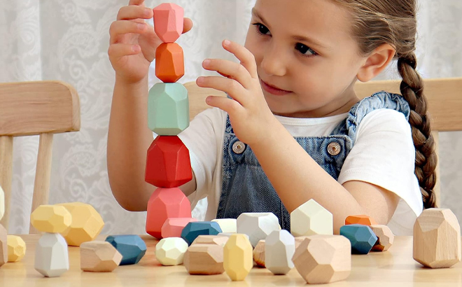 A Child Playing With the Bestamtoy 36 Piece Wooden Sorting Stacking Rocks Stones