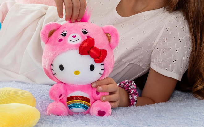 A Child Playing with the Care Bears Hello Kitty Dressed As Cheer Bear 8 Inch Fun Size Plush