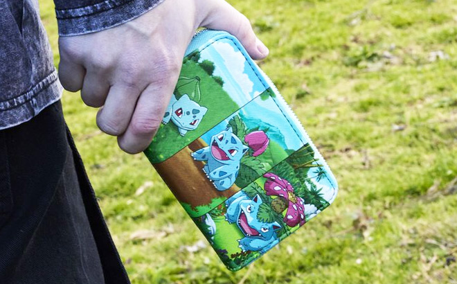 A Person Holding Loungefly Pokemon Bulbasaur Evolution Zip Around Wallet