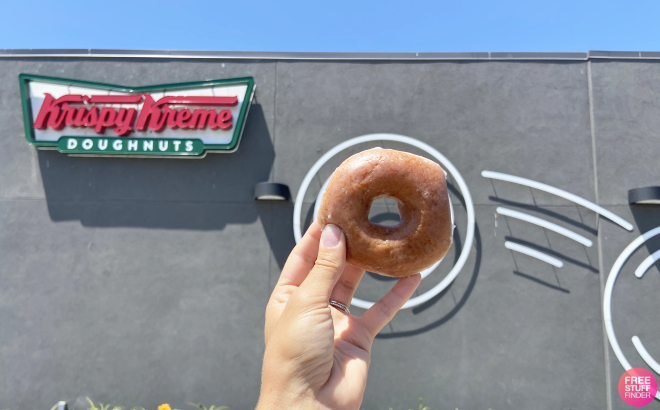 A Person Holding a Krispy Kreme Original Glazed Doughnut