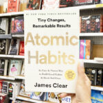 A Person Holding an Atomic Habits Book