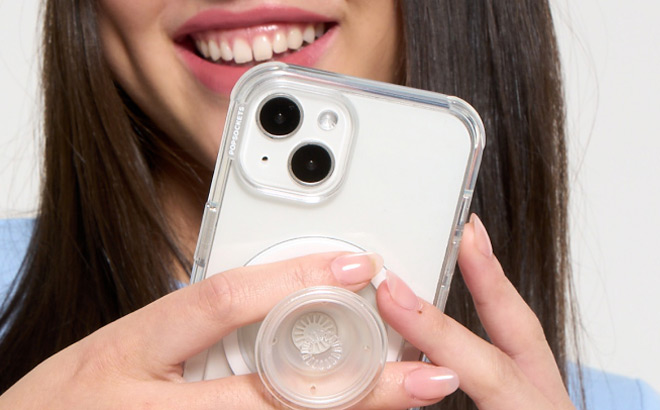 A Person Using a phone with PopSockets MagSafe Phone Grip attached