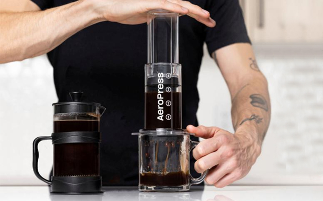 A Person Using the AeroPress Tinted 3 in 1 Brewing Coffee Press