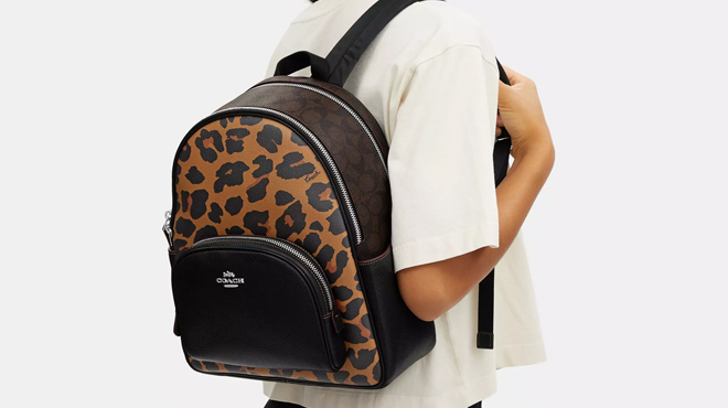 A Person Wearing Animal Print Coach Backpack