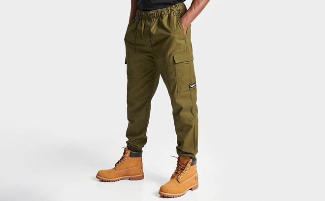 A Person Wearing Timberland Utility Cargo Jogger Pants in Olive Color