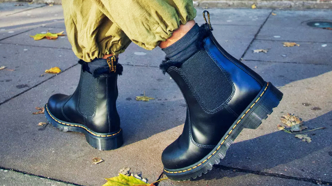 A Person Wearing a Pair of Dr Martens Faux Fur Lined Chelsea Boots