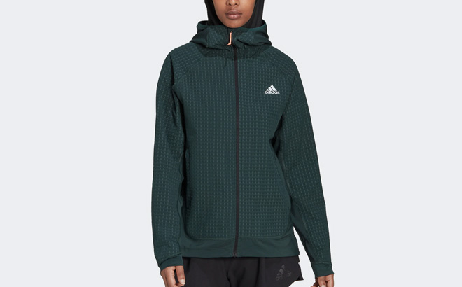 A Person is Wearing Adidas Womens X City Running Soft Shell Jacket in Shadow Green Color