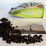 A Postcard Coffee Bag and Coffee Beans on a Tabletop