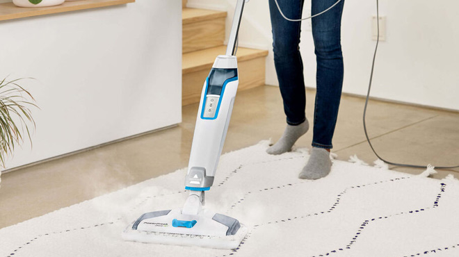 A Woman Cleaning with the Bissell PowerFresh Deluxe Pet Scrubbing Steam Mop with SpotBoost Brush