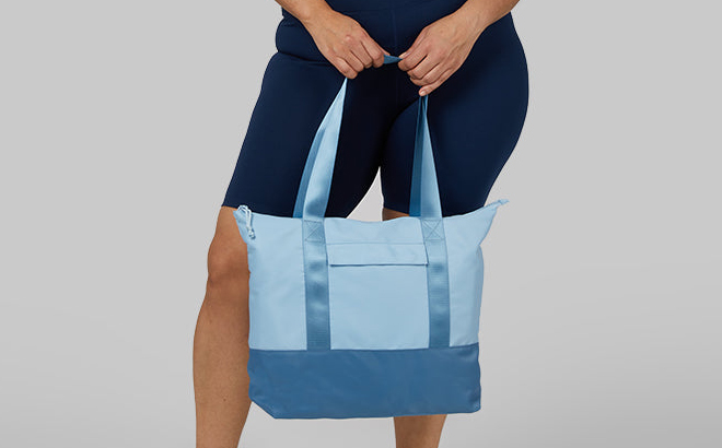 A Woman Holding 32 Degrees Travel Tote Bag