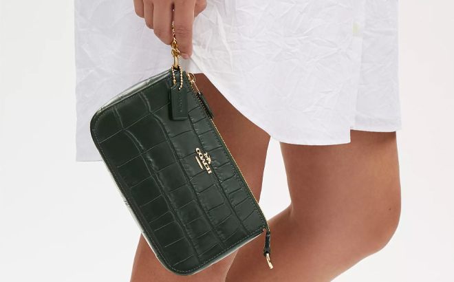 A Woman Holding Coach Outlet Nolita 19 Bag in Amazon Green