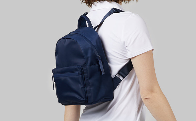 A Woman Wearing 32 Degrees Mini Backpack in Navy Color