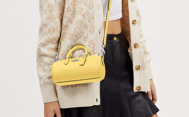 A Woman Wearing Coach Outlet Lacey Crossbody in Retro Yellow