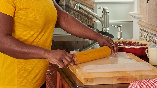 A lady using a Reynolds Cut Rite Wax Paper in the Kitchen