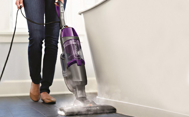 A Person Operating the Bissell Symphony Plus Vac and Steam Mop with Accessories