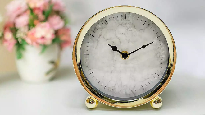 Gold Tone Metal Clock Table Decor on a Table