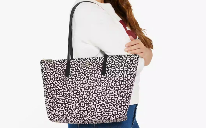 Hand Holding Kate Spade Kitt Leopard Large Tote in Black Multi Color