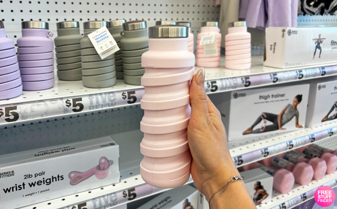 Hand Holding a Collapsible Water Bottle in Pink