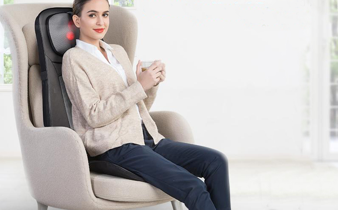 Woman Sitting on a Chair Using a Snailax Shiatsu Full Back Massager with Heat