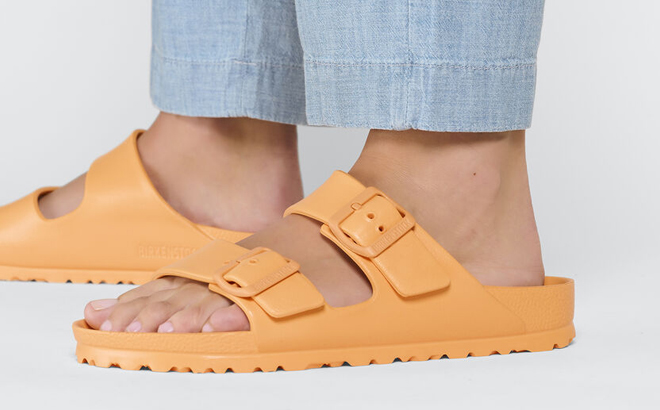 Woman Wearing Birkenstock Arizona Eva Narrow Sandals in Papaya