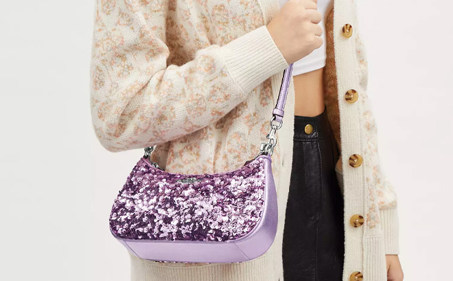 Woman is Wearing Coach Teri Shoulder Bag in Silver Lilac Color