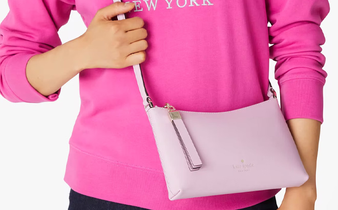 Woman is Wearing Kate Spade Sadie Crossbody in Blossom Pink Color