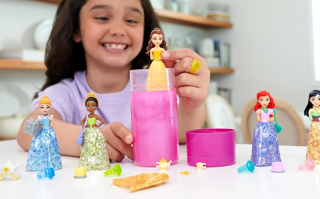 A Kid is Holding Mattel Disney Princess Small Doll Royal Color Reveal