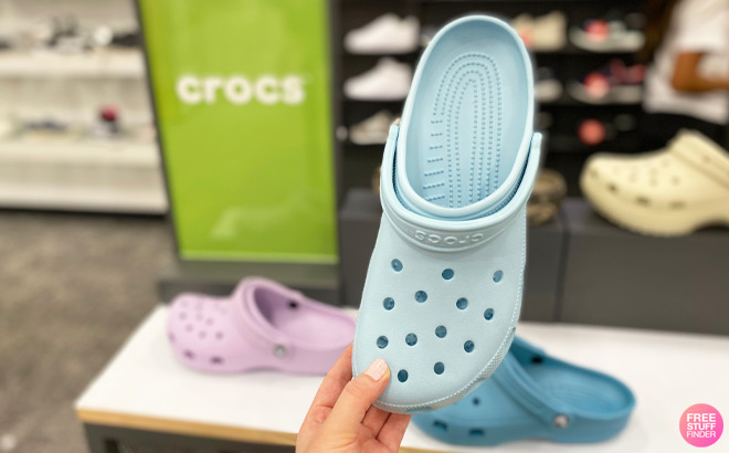 A Person Holding Crocs Classic Clogs