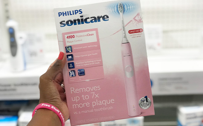 A Person Holding Philips Sonicare 4100 Plaque Control Rechargeable Electric Toothbrush