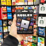 A Person Holding Roblox Gift Card