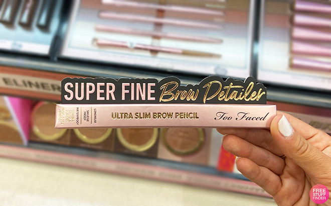 A Person Holding Too Faced Super Fine Brow Detailer Pencil