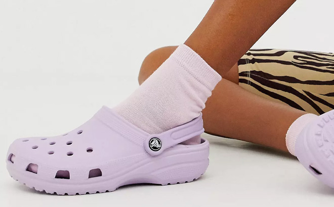 A Person Wearing Crocs Classic Clog in Lavender Color