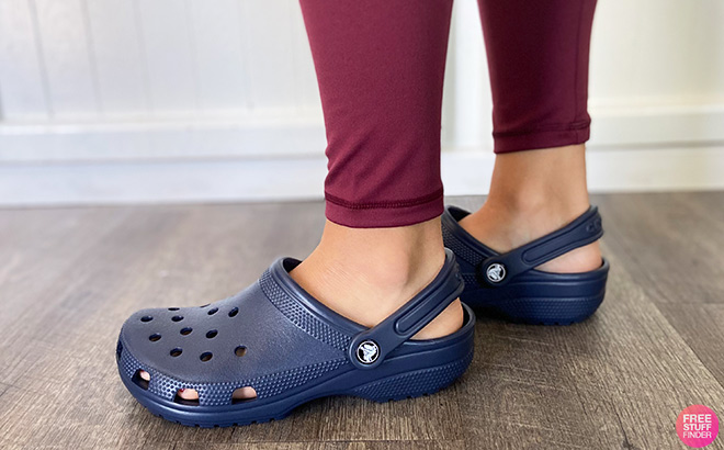 A Person Wearing Crocs Classic Clogs in Blue Color