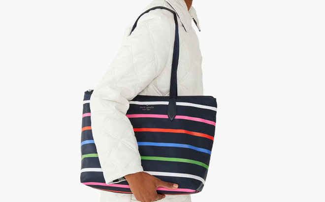 A Person is Holding Kate Spade Outlet Mel Packable Tote in Multi Color