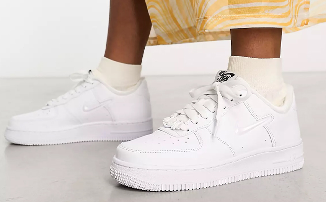 A Woman Wearing Nike Air Force 1 07 Sneakers in White