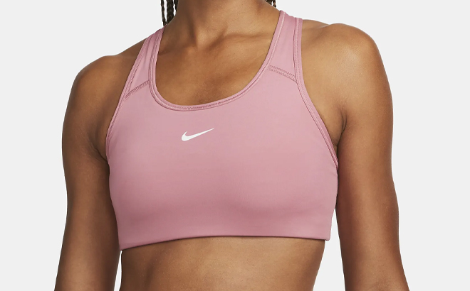 A Woman Wearing Nike Swoosh Medium Support 1 Piece Pad Sports Bra