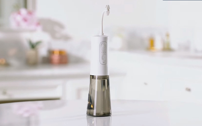 Miracle Smile Deluxe Pro Water Flosser on a Bathroom Counter