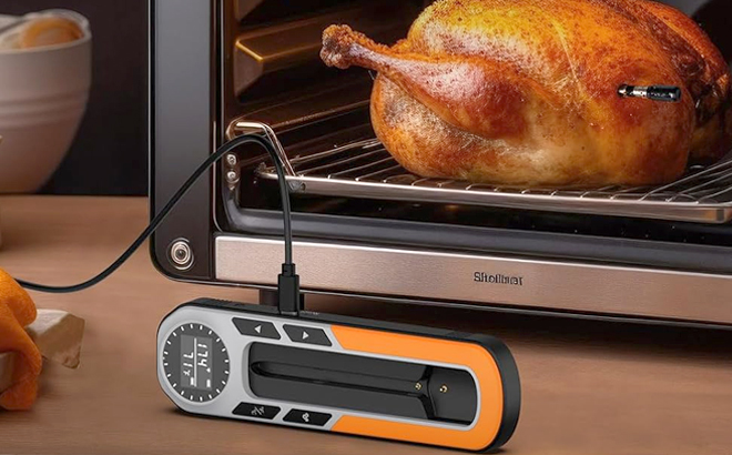 QGH Wireless Smart Meat Thermometer in Front of an Oven with a Chicken in It