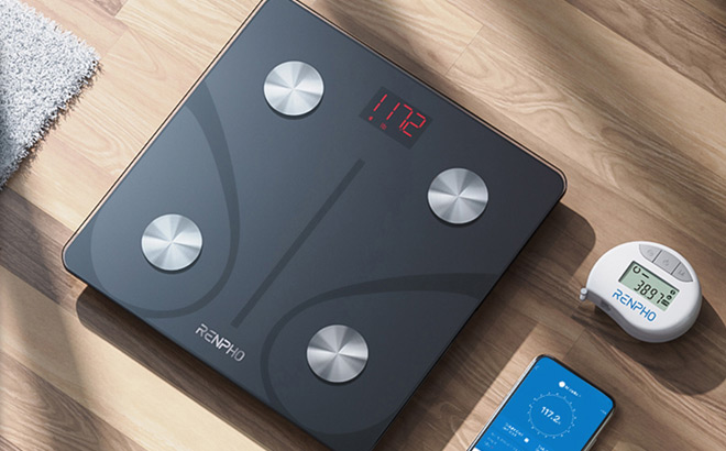 Renpho Smart Body Weight Scale on the Floow with A Phone On the Side