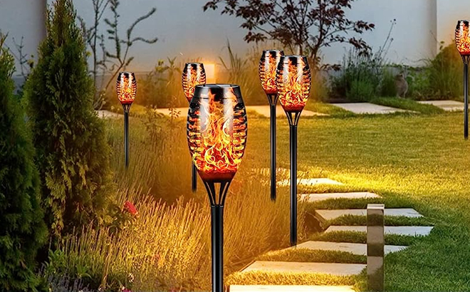 Solar Outdoor Tiki Torches Lights with Flickering Flame in a Frontyard