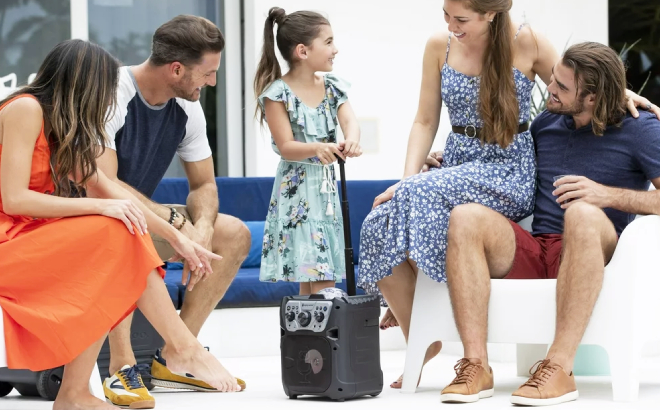 A Family with a Girl Holding a Singing Machine Fiesta Go