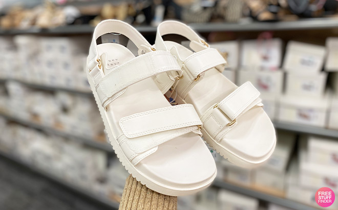 A Person Holding A New Day Womens Jonie Ankle Strap Footbed Sandals in Off White Color at Target