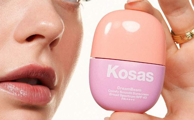 A Person Holding Kosas DreamBeam Silicone Free Mineral Sunscreen