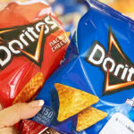 A Person Holding a Bags of Doritos Nacho Cheese and Cool Ranch Chips