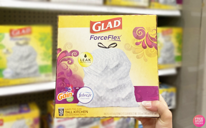 A Person Holding a Box of Glad ForceFlex Tall Kitchen Drawstring Trash Bags