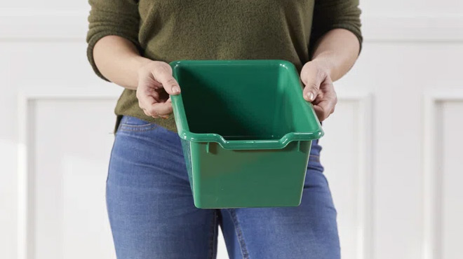 A Person Holding a Green ECR4Kids Front Storage Bin