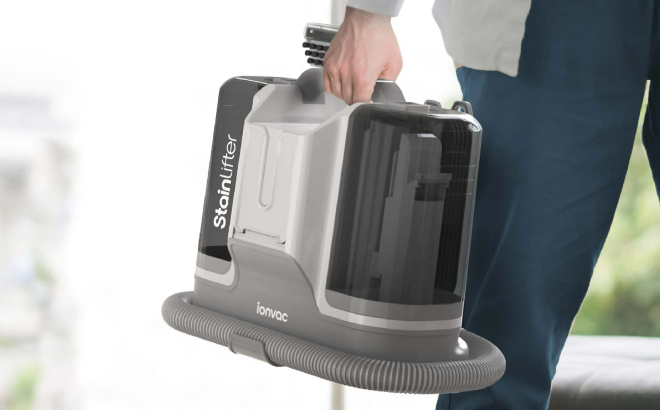 A Person Holding an Ionvac Stain Lifter Vacuum Cleaner