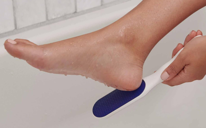 A Person Using Dr Scholls Nano Glass Foot File on Shower