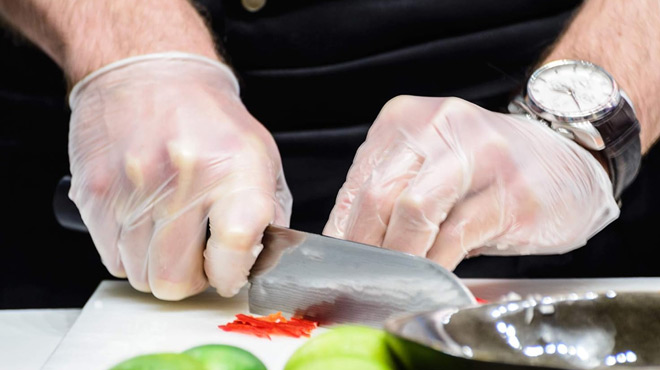 A Person Wearing a Dre Health Disposable Gloves while Chopping Some SPices
