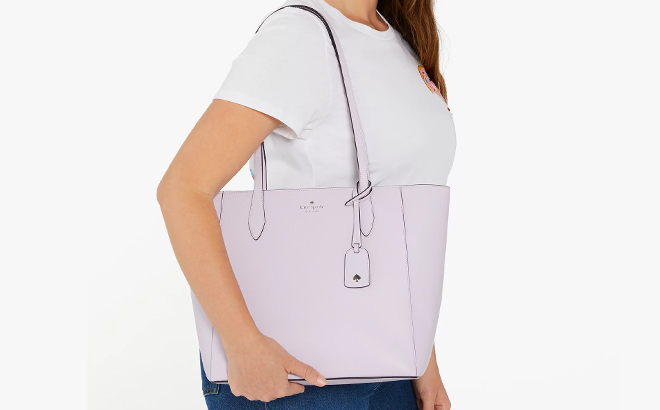 A Woman Wearing Kate Spade Dana Tote in Violet Spritz